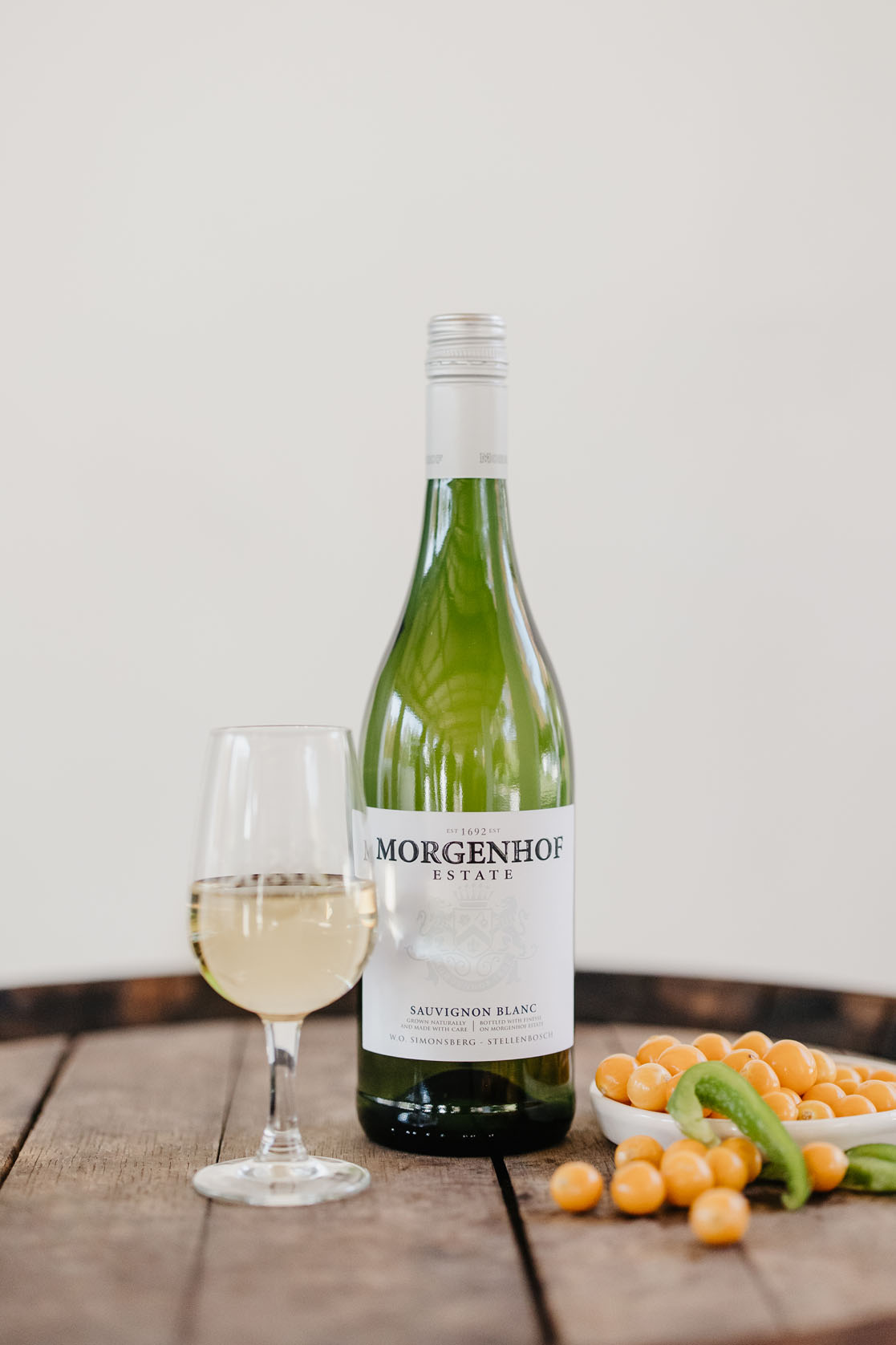 Morgenhof Estate Sauvignon Blanc with a glass of white wine and gooseberries